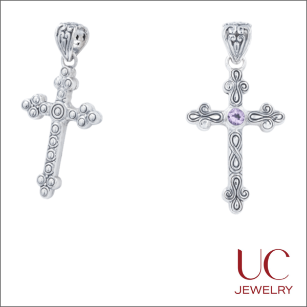 Exquisite sterling silver cross pendants by UC Jewelry, featuring intricate artisan metalwork. Choose between a granulated silver design with classic beaded textures or an elegant amethyst-centered cross with fluid scrollwork and fleur-de-lis accents. Both pieces showcase a vintage, oxidized finish and decorative bails, perfect for a timeless expression of faith.