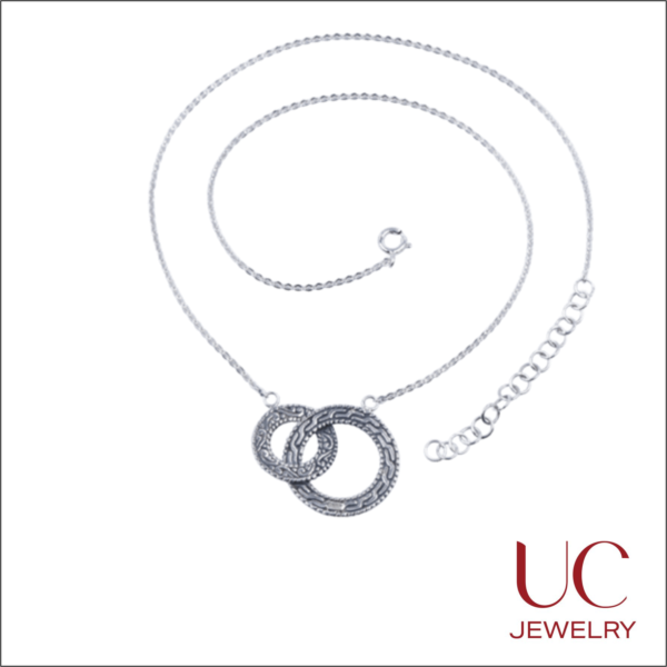 Celebrate an unbreakable bond with this handcrafted .925 sterling silver necklace. Featuring two interlocking circles with intricate, oxidized scrollwork, this adjustable piece is the perfect symbolic gift for mothers, daughters, or partners. Shop the timeless unity pendant today.